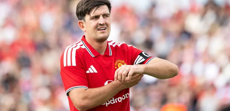 Player adjusting wrist while wearing Manchester United jersey