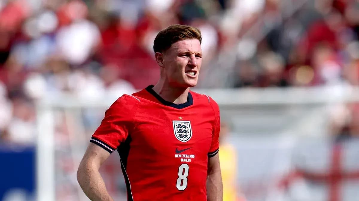 Player in red England jersey during match action