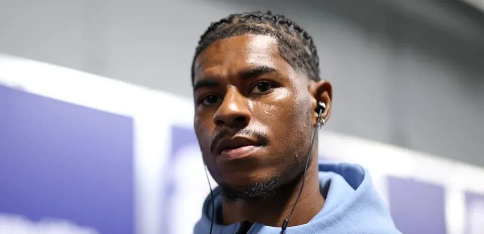 Athlete wearing headphones, looking at the camera