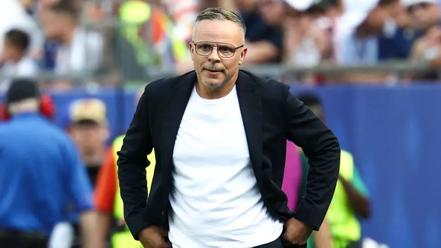 Coach walking along the sideline during match