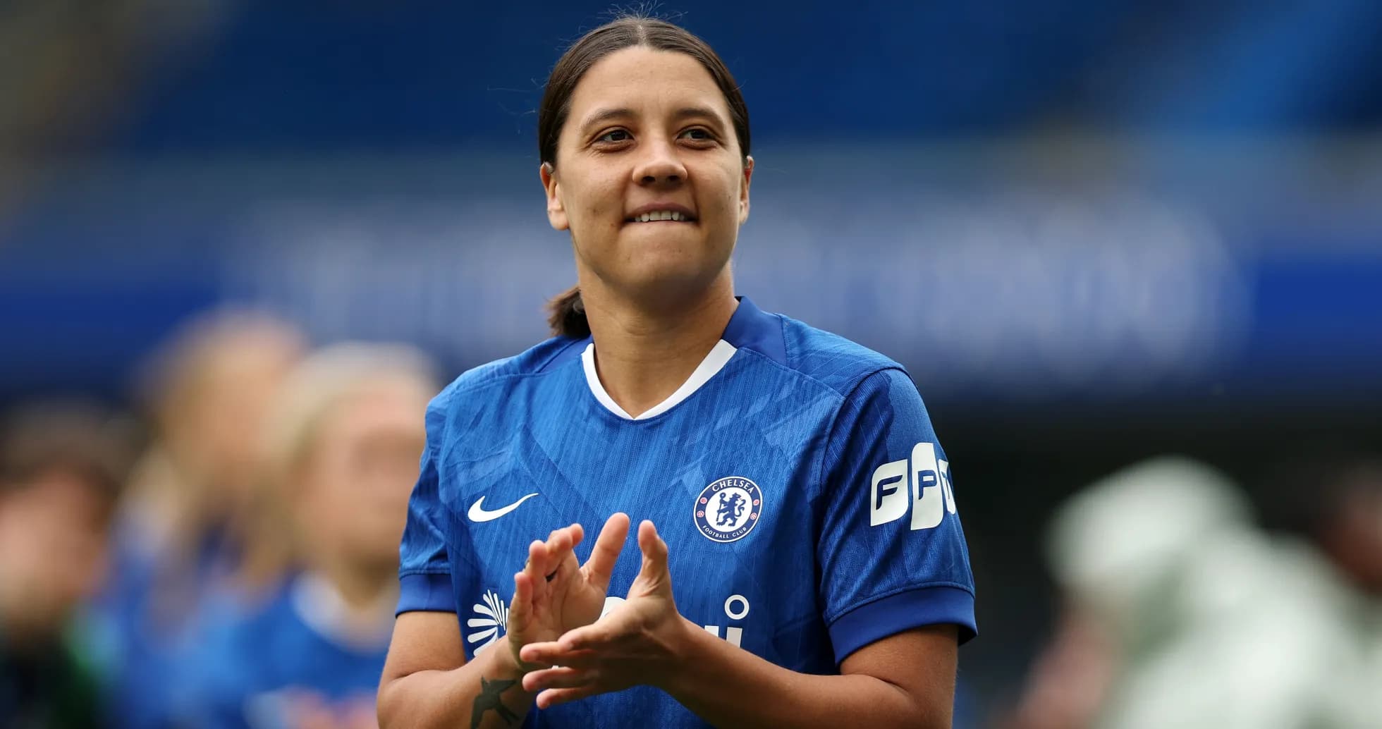 Player in blue jersey clapping on the field