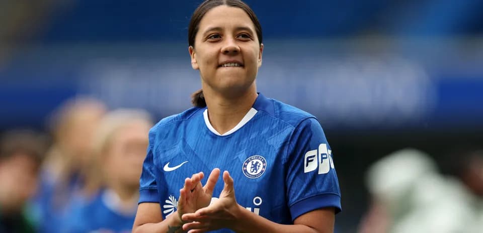 Player in blue jersey clapping on the field