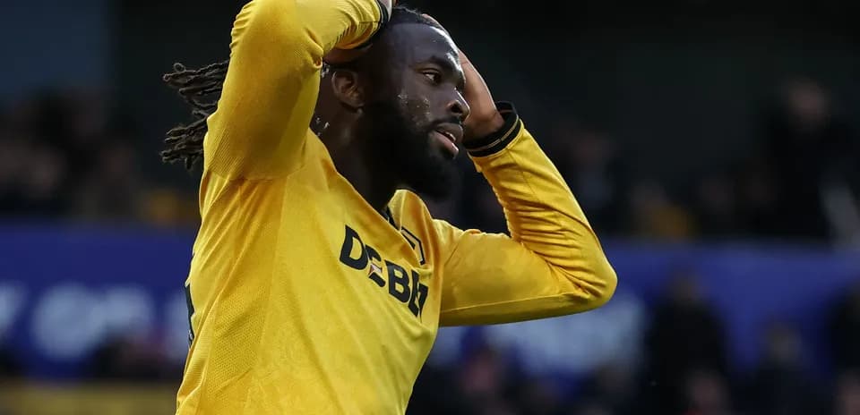 Player in yellow shirt expressing frustration on field