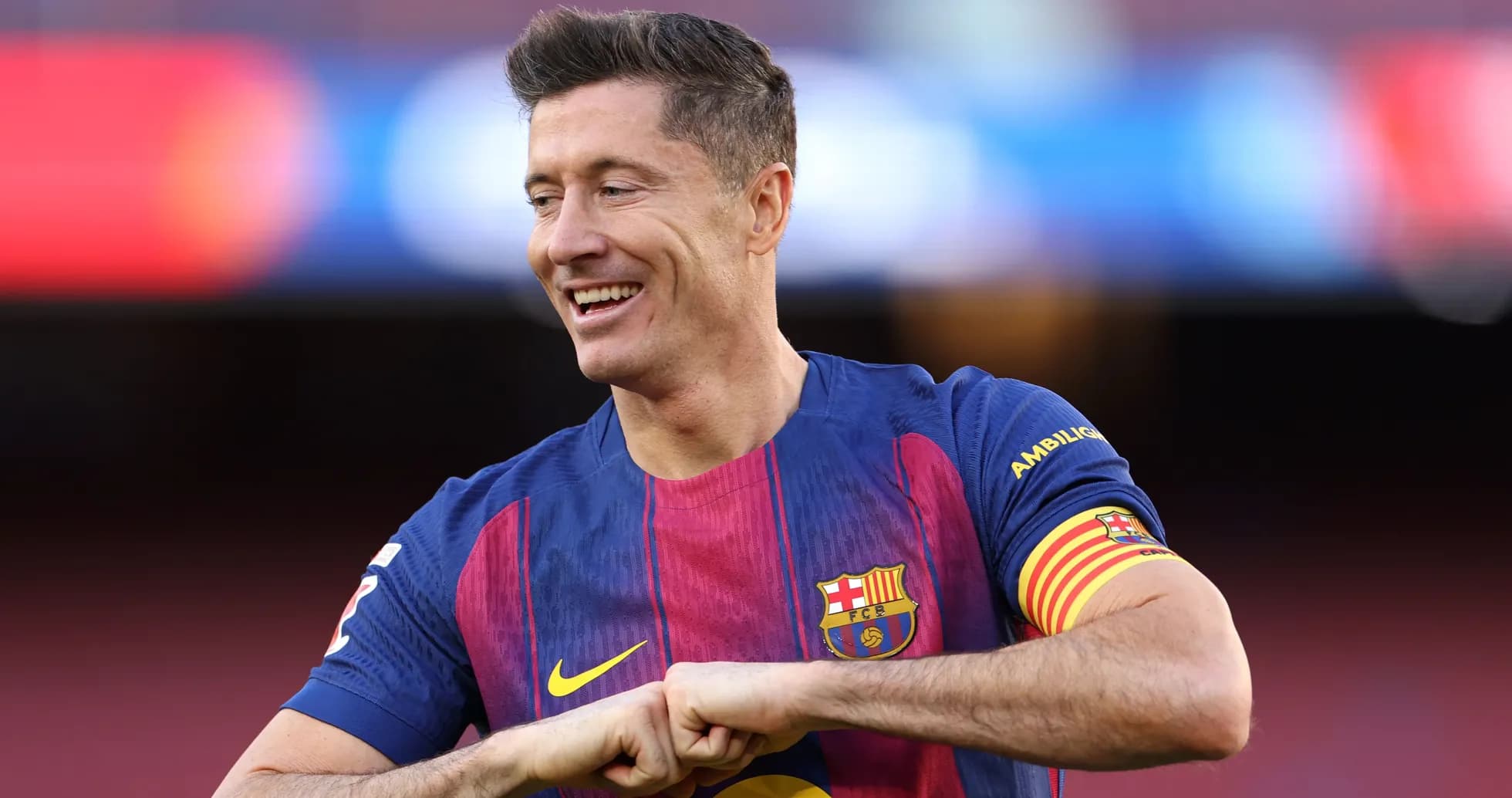 Player in Barcelona jersey smiling on the field