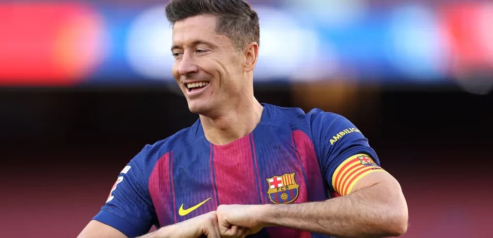 Player in Barcelona jersey smiling on the field