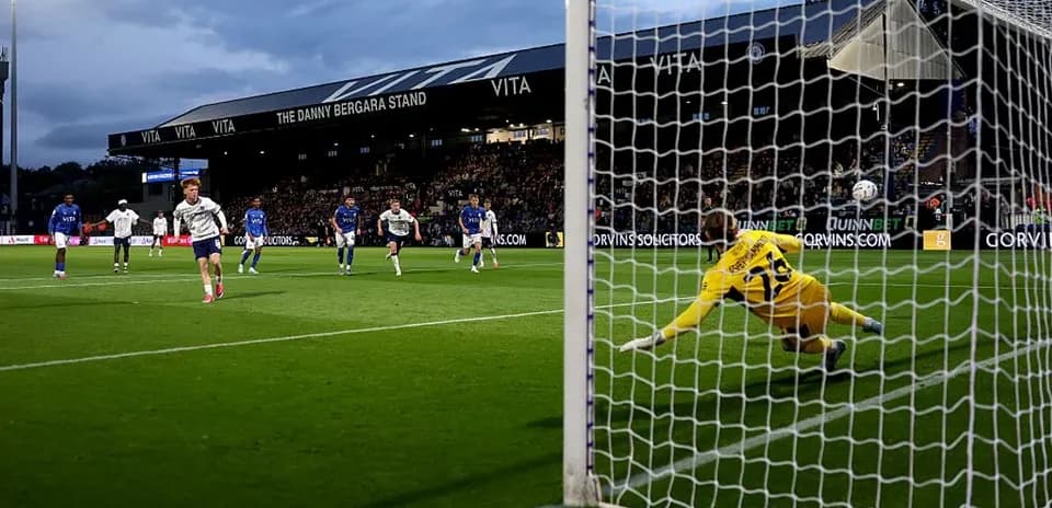 Player taking a penalty kick against the goalkeeper