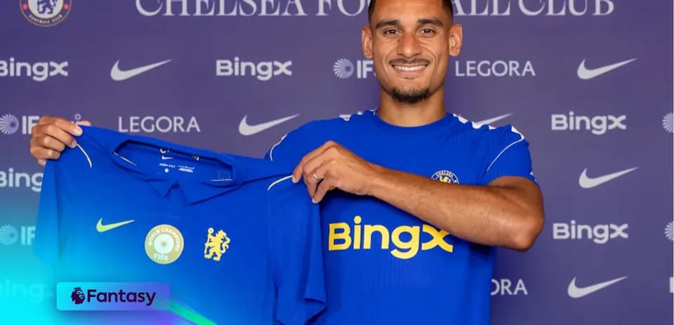 Player holding Chelsea FC jersey during signing event
