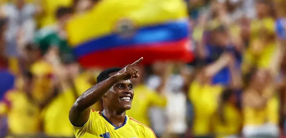 Player celebrating with fans in yellow jerseys