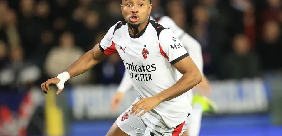 Player wearing AC Milan kit during match action