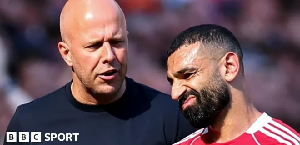 Coach speaking with player on the field