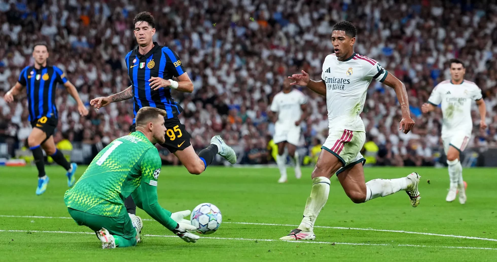 Real Madrid player sprinting past goalkeeper during match