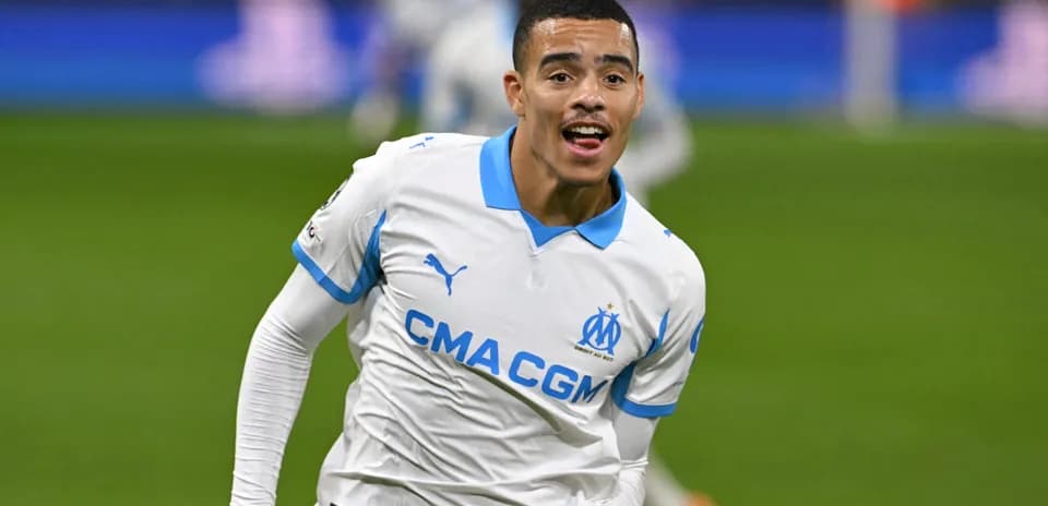 Player celebrating goal in Marseille jersey on pitch