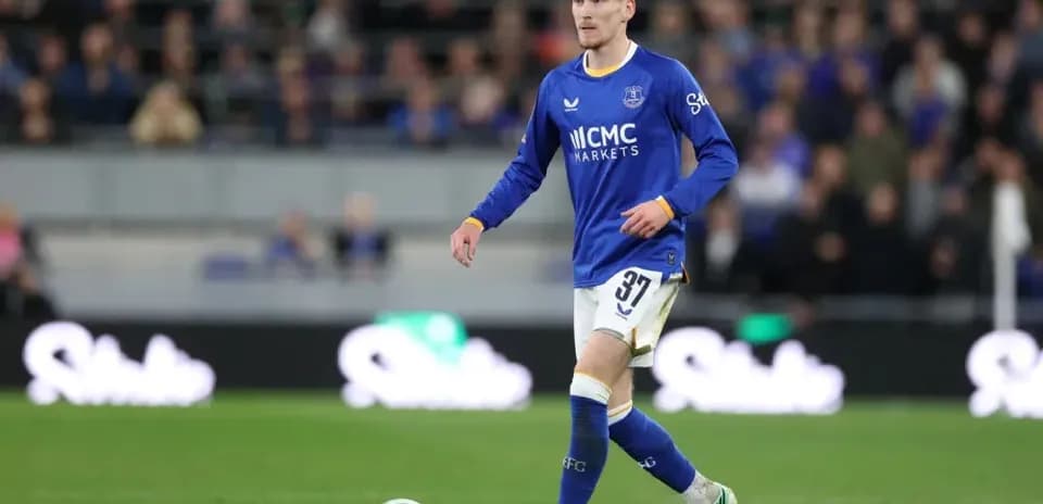 Player in blue kit walking on the pitch
