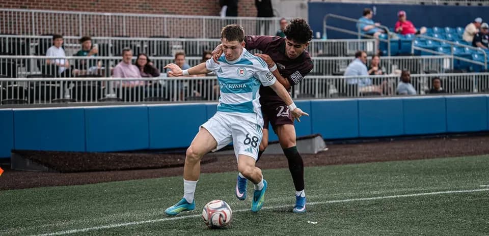 Player competing for ball in Carolina Core match
