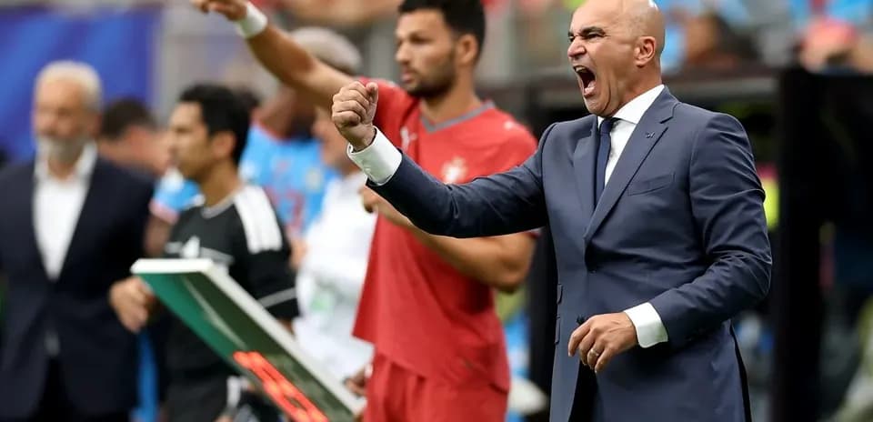 Coach celebrating during a match on the sidelines