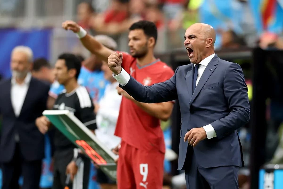 Coach celebrating during a match on the sidelines