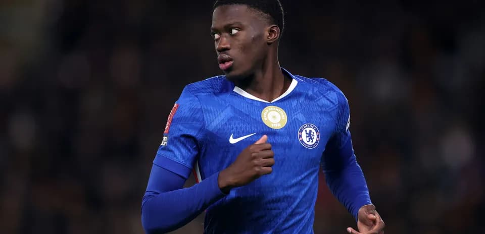 Player in blue Chelsea kit running during match
