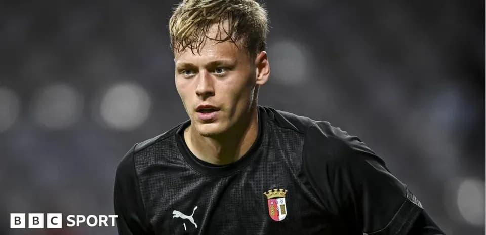 Goalkeeper in black kit preparing for match