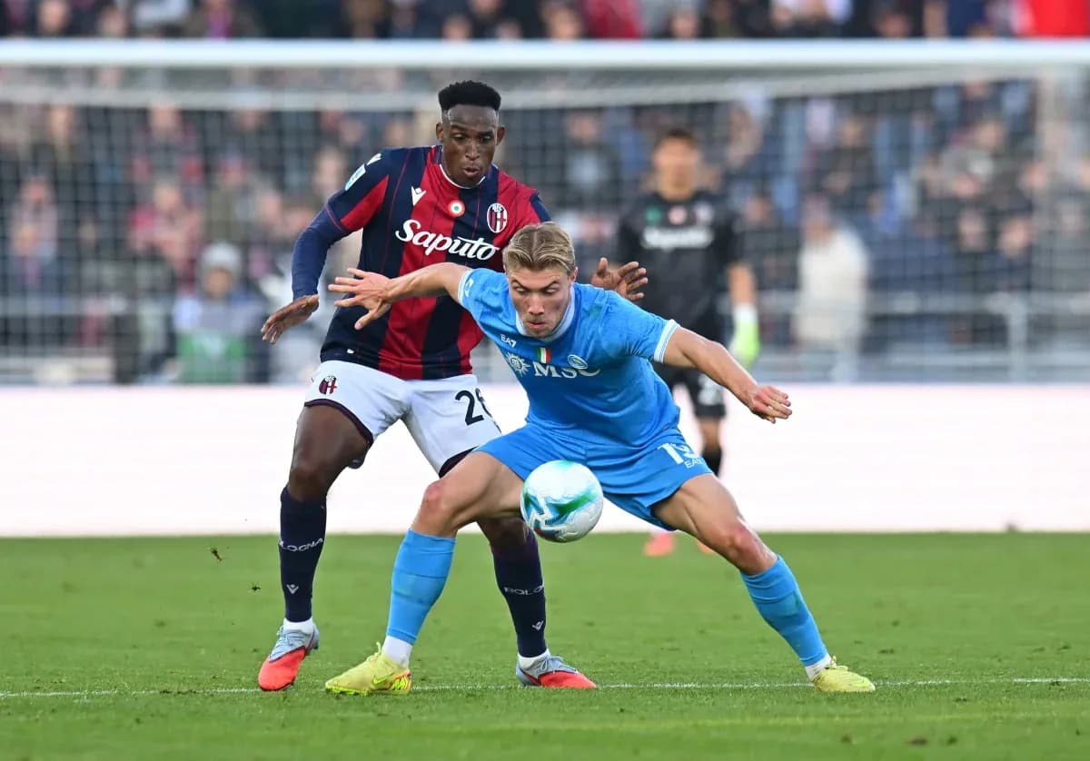 Napoli player challenging Bologna opponent for the ball
