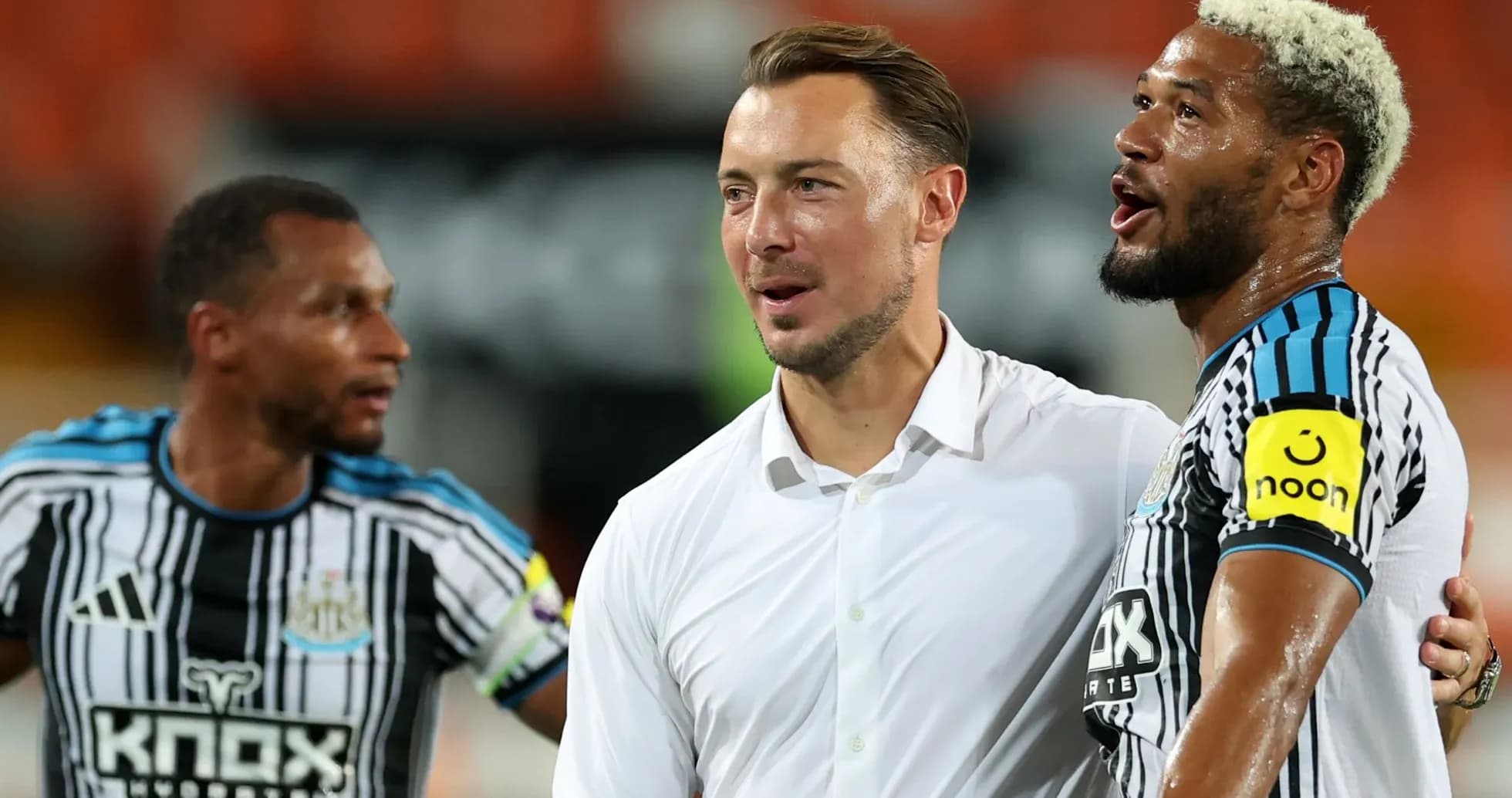 Newcastle players celebrating with their manager post-match