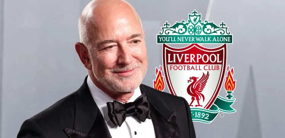 Man in tuxedo with Liverpool FC logo background