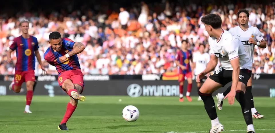Barcelona player shooting on goal during match