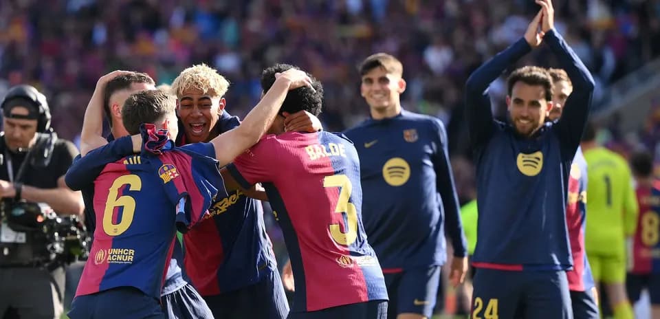 Barcelona players celebrating together on the pitch