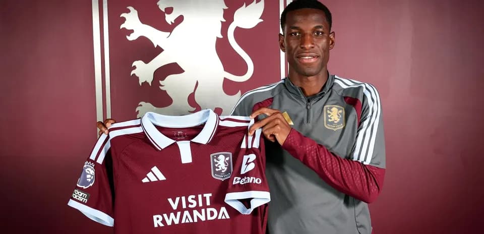 Player holding Aston Villa jersey during unveiling