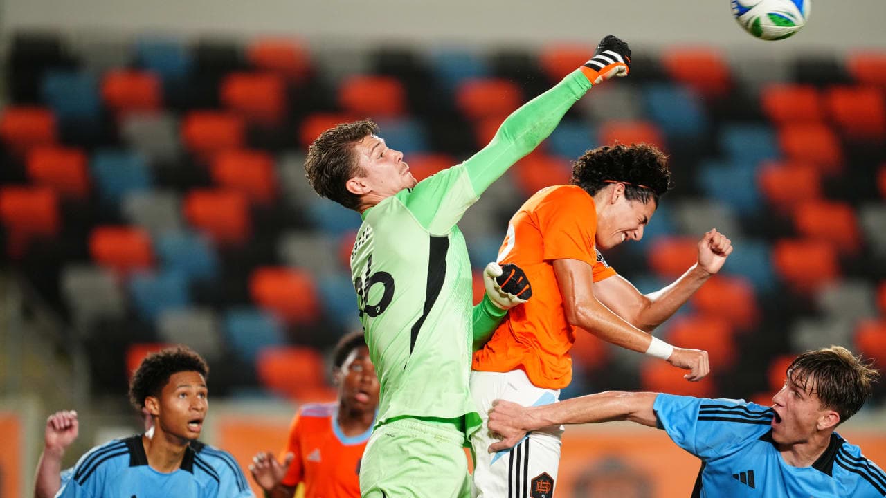 Goalkeeper punches ball during MLS Next Pro match