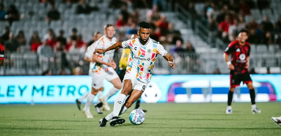 Phoenix Rising player dribbling the ball
