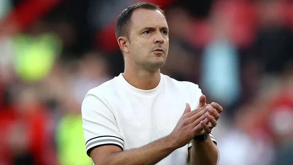 Manager applauding during a match on the sideline
