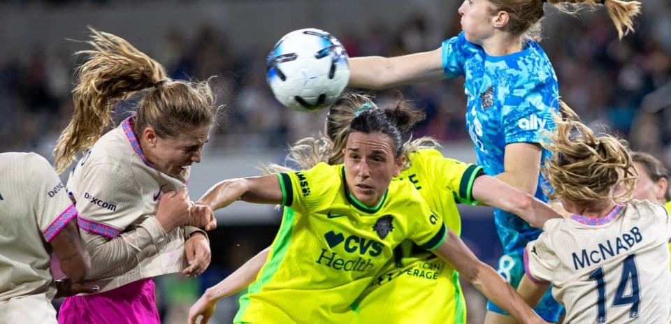 Players contesting a high ball during match