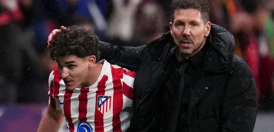 Atletico Madrid player receiving support from coach