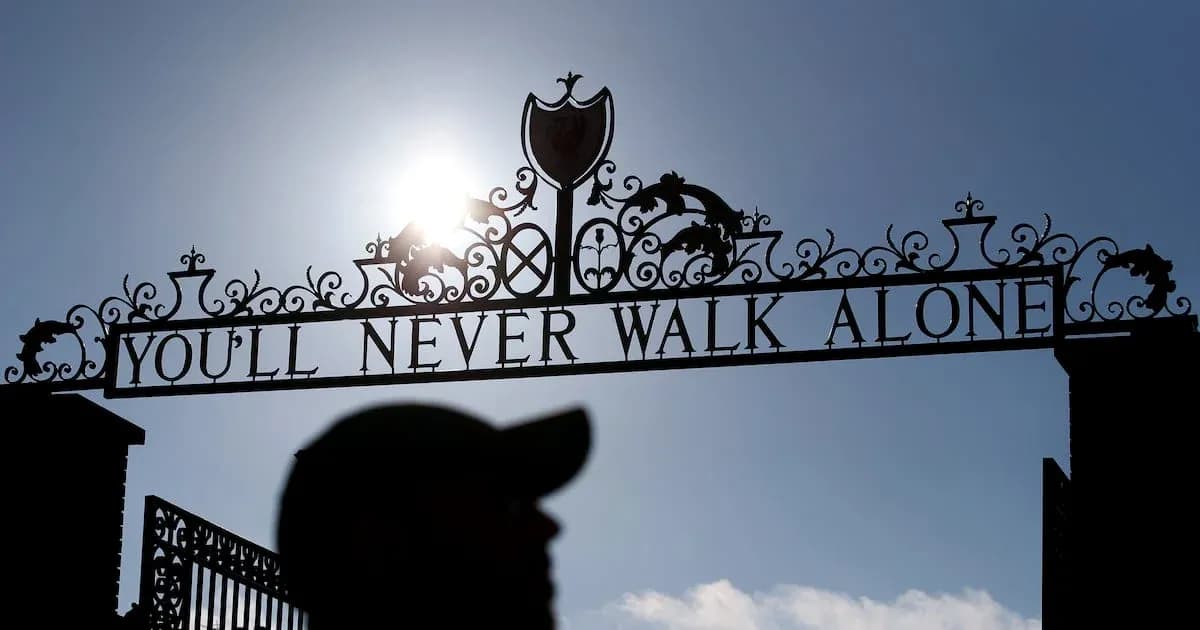Sign reading 'YOU'LL NEVER WALK ALONE' at stadium entrance