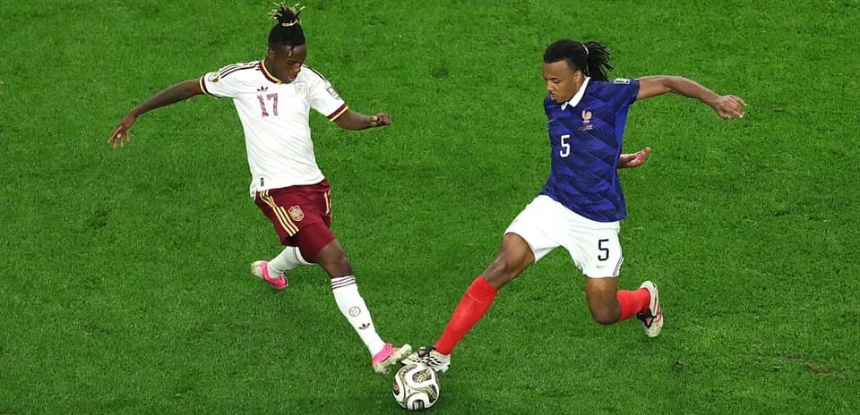 Two players contesting the ball during match