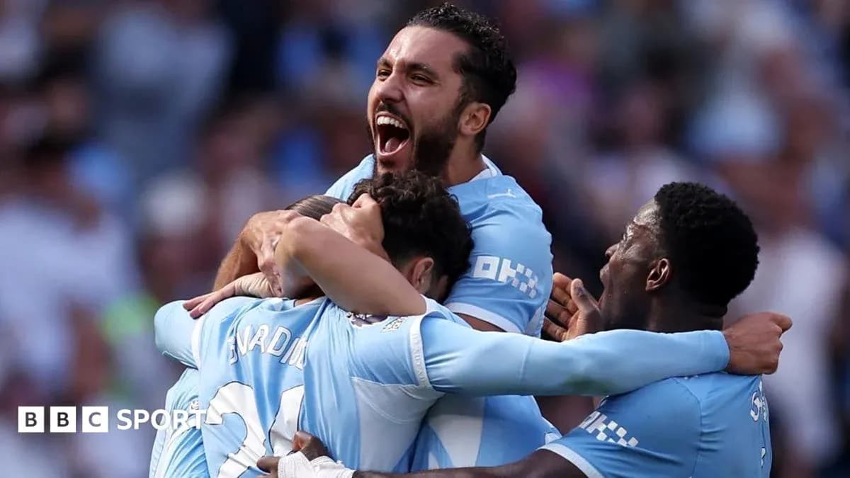 Players celebrating a goal in light blue jerseys