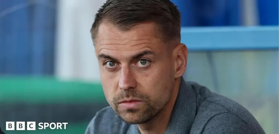 Man with short hair looking directly at camera
