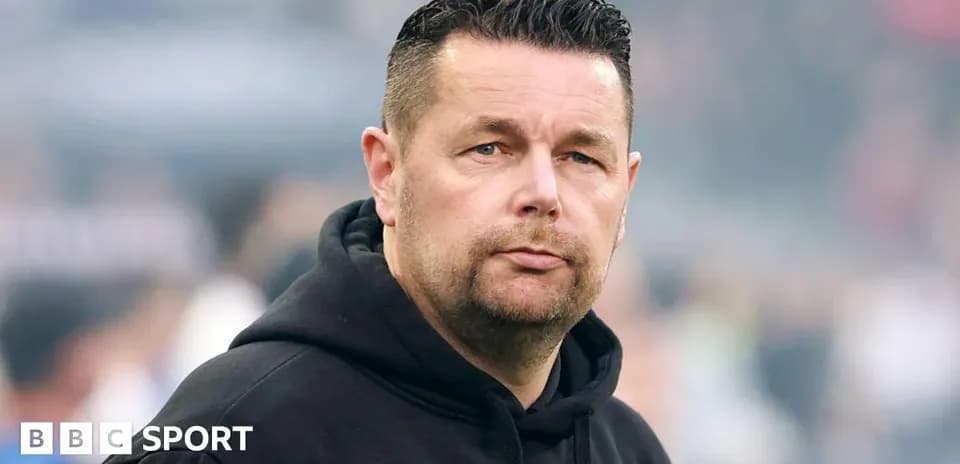 Man in black hoodie observing the field