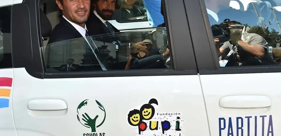 Two men in suits sitting in a car
