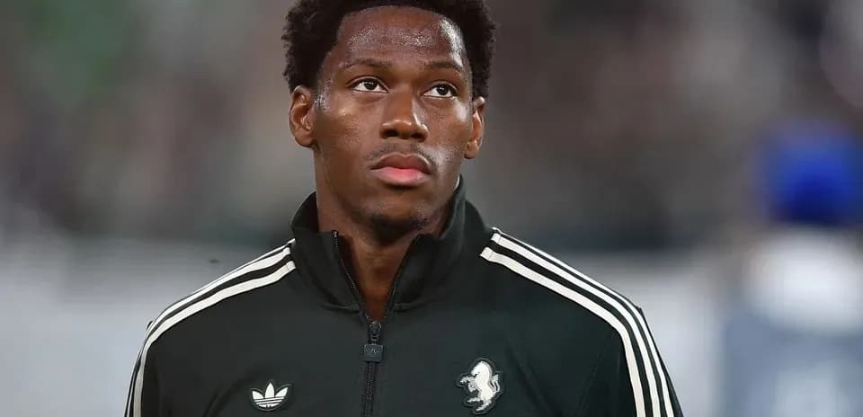Player in black warm-up jacket looking ahead