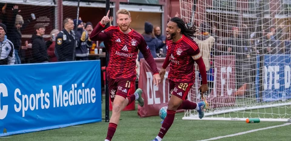 Players celebrating goal during Detroit City match