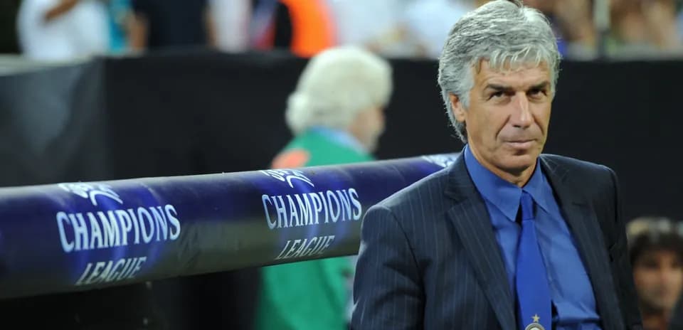 Coach sitting near Champions League bench during match