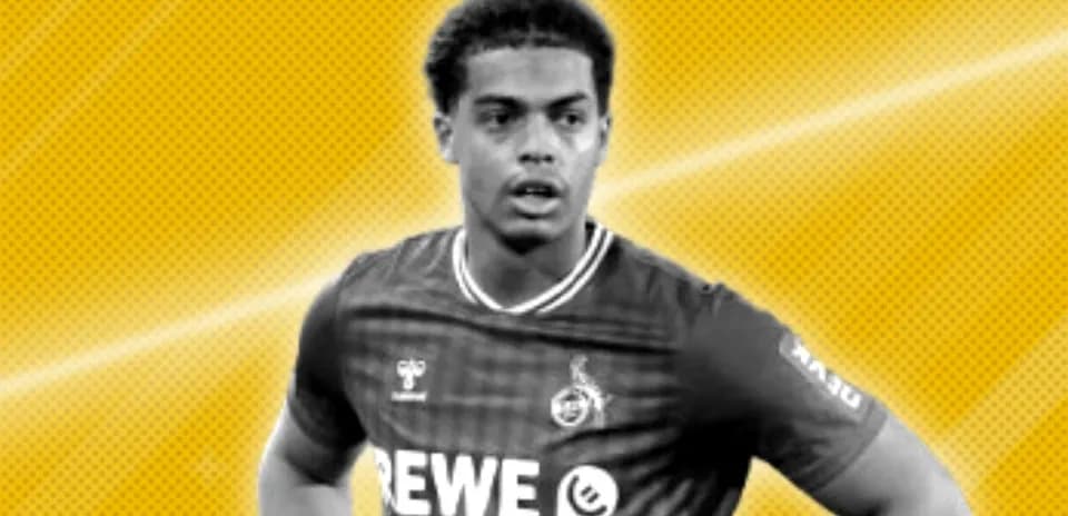 Player wearing REWE jersey on yellow background