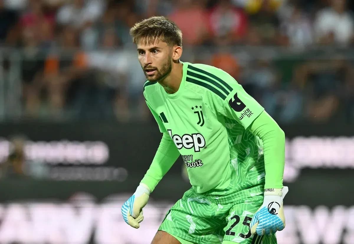 Goalkeeper in green kit preparing for play
