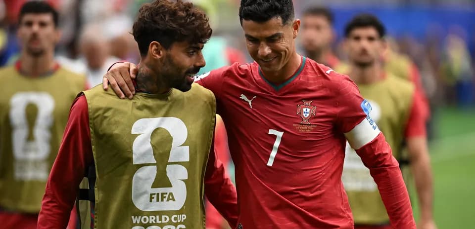 Two Portuguese players interacting before the match