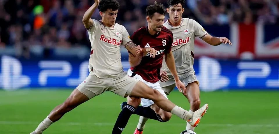 Players competing for the ball in UEFA match
