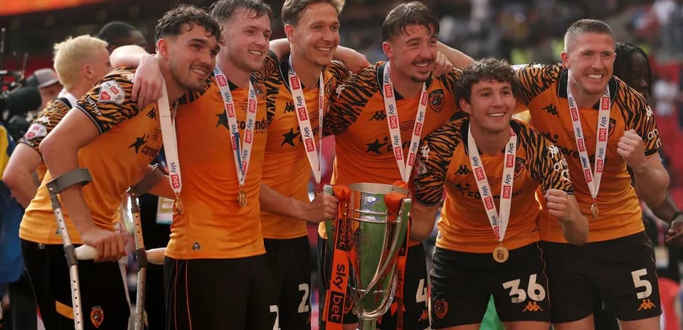 Players celebrating with trophy after match victory