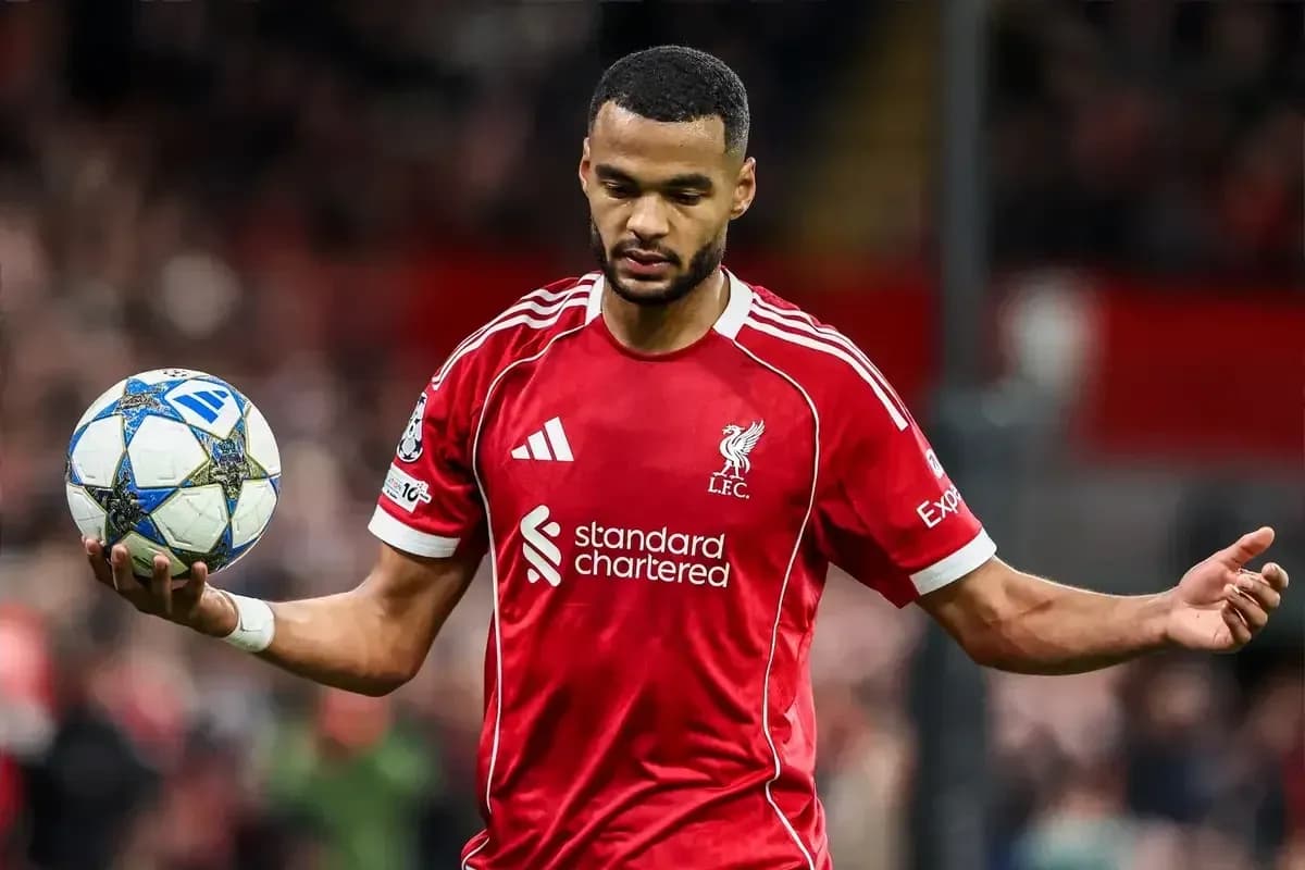 Player in Liverpool kit holding a football