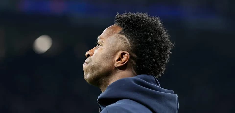 Player looking on during match from sidelines