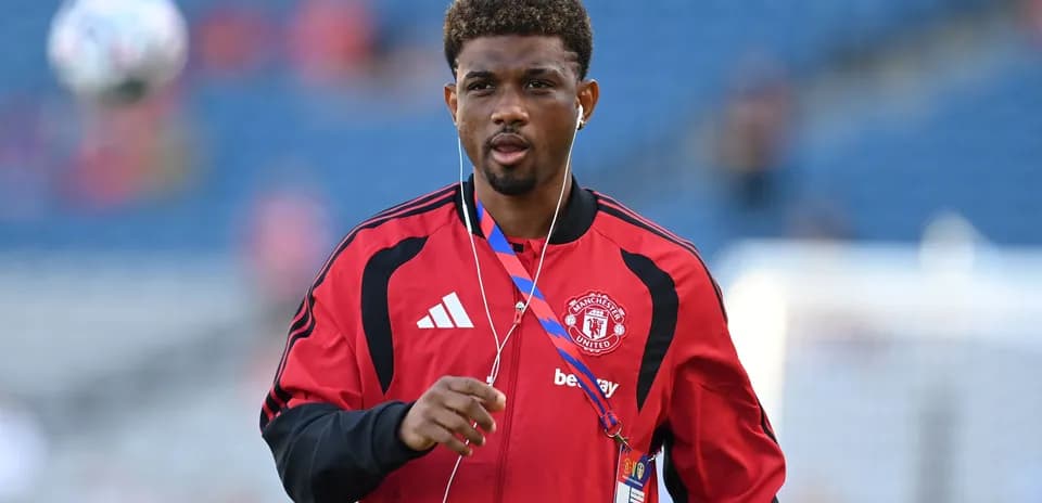 Player in Manchester United training gear on pitch